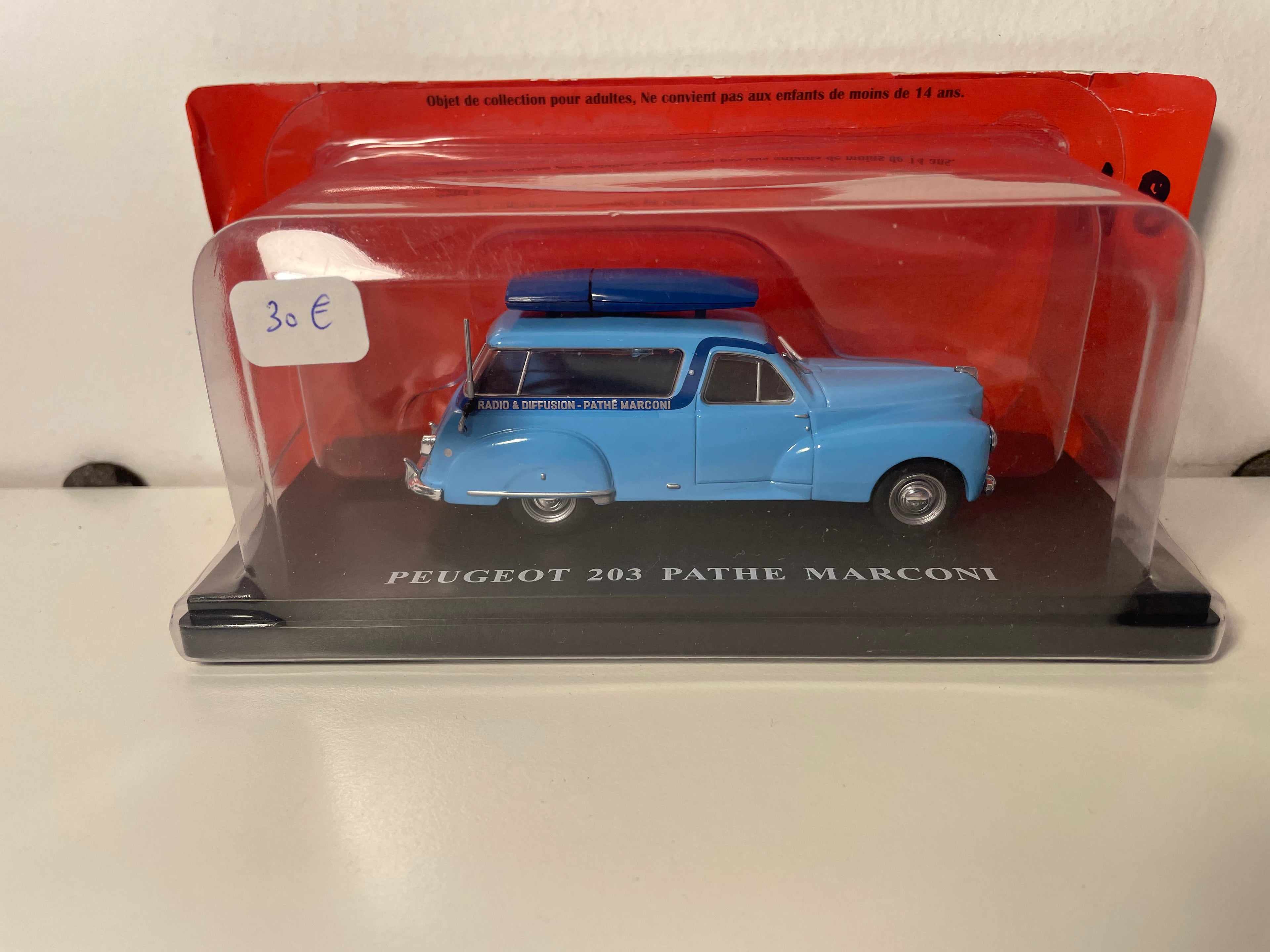 Peugeot 203 station wagon blue with Pathé Marconi radio advertisement