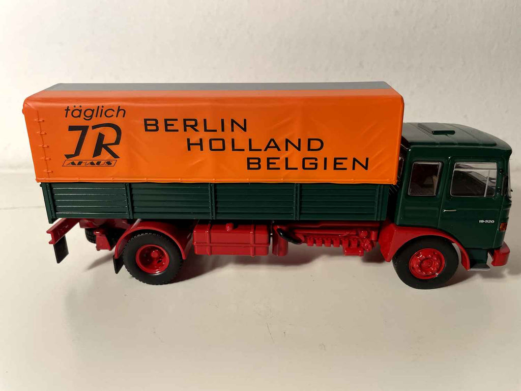 Man Büssing Unterflur truck from 1975 with green platform and orange "Holland" tarpaulin