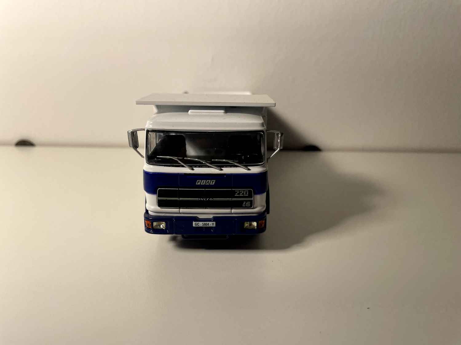 FIAT IVECO 619 truck with white cab and blue and white dump body