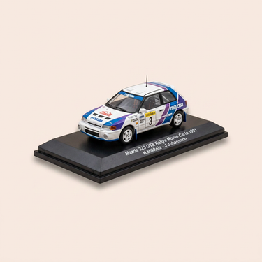 Voiture miniature - Mazda 323 GTX blanche, bleue, verte et violette numéro 10 - rallye de Monté-Carlo de 1991