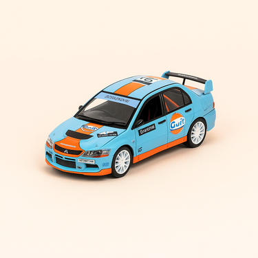 Photo professionnelle de la voiture miniature Mitsubishi Lancer Evolution Ix Aux Couleurs De Gulf Bleue Et Orange Rallye Direland De 2009 Numero 63E 1969 Numero 6 - Image clean haute qualité